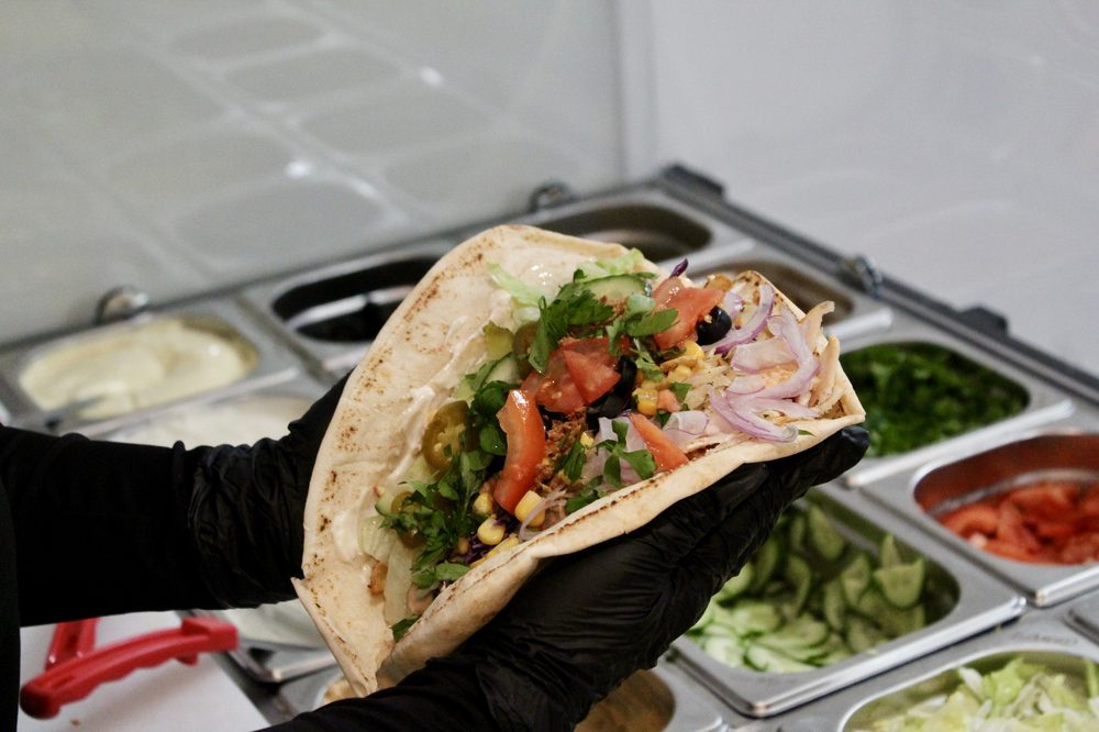 Fresh pita loaded with kebab meat and toppings