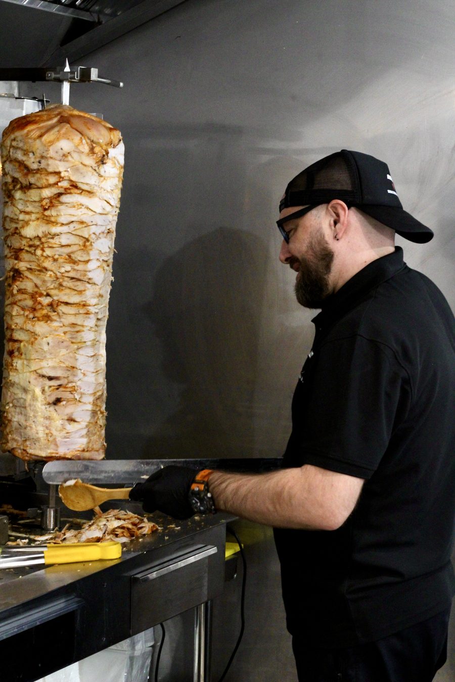 Freshly grilled kebab meat being sliced
